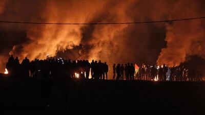 Palestinian protesters take part in a night demonstration near the fence along the border with Israel, east of Gaza City. AFP