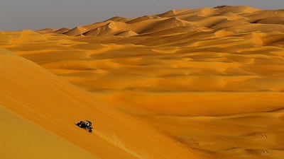 The stunning sandscape of the 300-metre high Tel Moreeb dune in Al Gharbia dwarfs participants yesterday at the Liwa International Festival, the popular seven-day winter event that features falconry and camel contests as well as dune bashing. Christopher Pike / The National