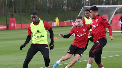 Paul Pogba, Diogo Dalot and Jadon Sancho battle for possession.