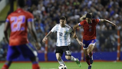 Argentina's Lionel Messi vies for a ball against Haiti's Zachary Herivaux. David Fernandez / AP Photo
