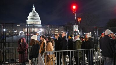 Members of the public wait to view the coffin.