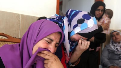 Relatives and friends of Saad Dawabsha mourn during his funeral in the West Bank village of Duma on August 8. AFP Photo