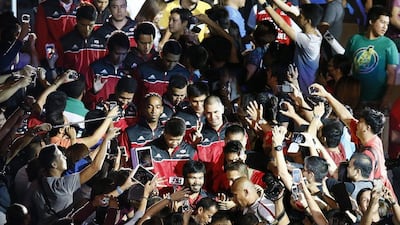 Manny Pacquiao, front, enters with the Kia-Sorento basketball club prior to their game against Blackwater-Elite in the Philippine Basketball Association on Sunday. Dennis M Sabangan / EPA