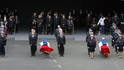 The coffins of the three police officers killed in the attacks are placed in the courtyard of the Paris police headquarters. Francois Mori / AP Photo
