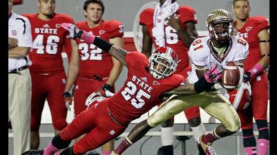 Lean on me: North Carolina State's Dontae Johnson (25) breaks up a pass intended for Florida State's Kenny Shaw during an NCAA college game. Gerry Broome / AP Photo