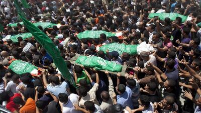 Palestinians carry the bodies of the ight members of the Al Hajj family who were killed in a strike early morning in Khan Younis refugee camp, southern Gaza Strip on July 10, 2014. Heidi Levine for The National