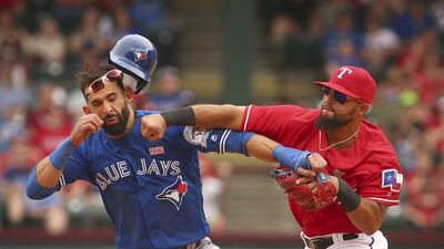 Toronto Blue Jays Jose Bautista (19) gets hit by Texas Rangers second baseman Rougned Odor (12) after Bautista slid into second in the eighth inning of a baseball game at Globe Life Park in Arlington, Texas. Richard W. Rodriguez / Star-Telegram via AP