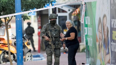 Israeli soldiers take position near a police station that was overrun by Hamas militants on Saturday in Sderot. AP