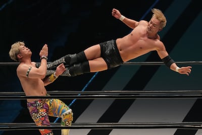 Japanese superstar wrestler Kazuchika Okada performs his signature dropkick on Kaito Kiyomiya. Getty Images
