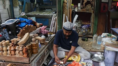 A man prepares food in Kolkata. India relies on the blockaded Strait of Hormuz to import cooking gas. EPA