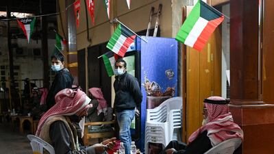 Customers relax at a coffee shop at Kuwait City's Souk Al-Mubarakiya. EPA