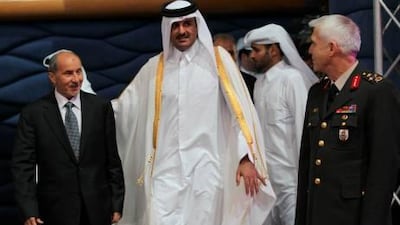 Qatari Crown Prince Sheikh Tamim bin Hamad Al Thani (C) arrives with Libya’s National Transitional Council (NTC) chairman Mustafa Abdel Jalil (L) at the Friends of Libya meeting held in Doha, Qatar on October 26.