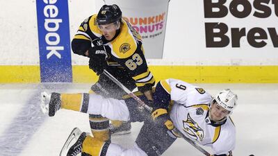 Boston Bruins left wing Brad Marchand, No 63, drops Nashville Predators centre Filip Forsberg to the ice during the first period of an NHL hockey game in Boston on Monday. Charles Krupa / AP Photo