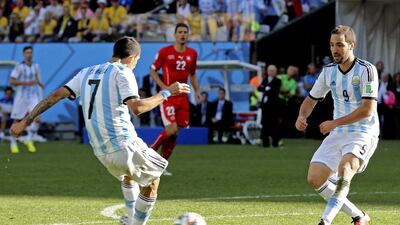 Argentina's Angel di Maria shoots to score the winner in the second half of extra time on Tuesday for a 1-0 victory over Switzerland at the 2014 World Cup. Sebastiao Moreira / EPA