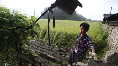 A South Korean earthquake victim stands by her damaged house following a 5.8 magnitude earthquake on September 12, in Gyeongju-city, Gyeongsangbuk-do. EPA