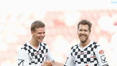 Mick Schumacher, son of Michael Schumacher, greets Sebastian Vettel (R) during the ‘Champions for Charity’ football match between Nowitzki All Stars and Nazionale Piloti in honour of Michael Schumacher at Opel Arena on July 27, 2016 in Mainz, Germany. Andreas Rentz / Getty Images