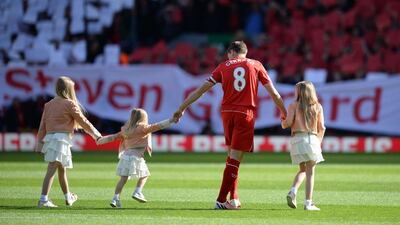 Steven Gerrard walks onto the pitch with his daughters. Oli Scarff / AFP
