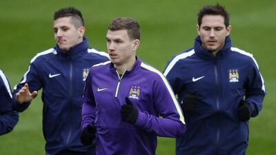 Edin Dzeko trains with Manchester City on Tuesday ahead of their Wednesday match against AS Roma in the Champions League. Phil Noble / Reuters / December 9, 2014