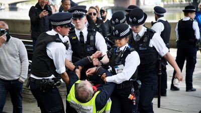 An anti lockdown protester is detained by police officers in London, following the outbreak of the coronavirus disease, London, Britain. Reuters