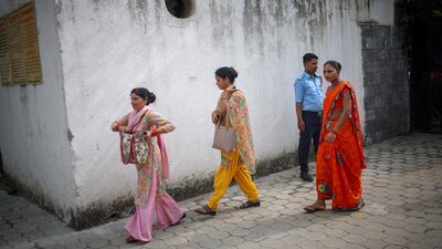 Employees arrive for work in Noida, Uttar Pradesh, where Nikki Bhati was killed last week. Reuters