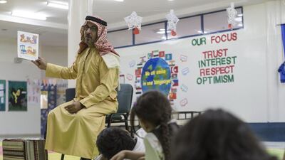 Fahad Abdelkareem Elnawaisah reads a story in his son’s class at Al Maaref Private School. Antonie Robertson / The National