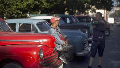 Taxi drivers wait for clients next to their classic American cars in Havana. Ramon Espinosa / AP Photo