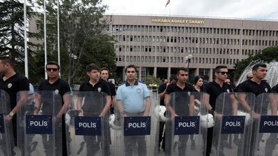 Turkish riot police stand guard outside a courthouse where prosecutors are questioning hundreds of coup plotters, in Ankara, Turkey, on July 20, 2016. Burhan Ozbilici / AP