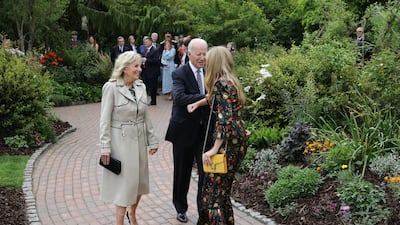 First Lady Dr Jill Biden paired her Gabriela Hearst trench coat with dark navy pumps and a Larroude’s Erin clutch. Getty