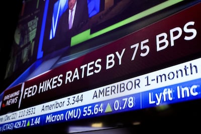 A screen displays the Fed rate announcement on the floor of the New York Stock Exchange in New York City. Reuters