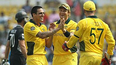 Mitchell Johnson celebrates with his teammates after the wicket of James Franklin, background, in Nagpur.
