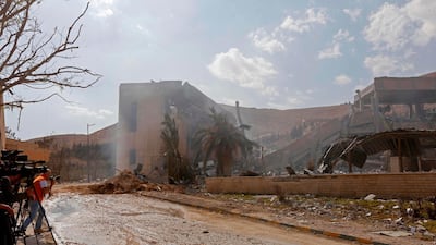 Journalists take pictures of the wreckage of a building described as part of the Scientific Studies and Research Centre (SSRC) compound in the Barzeh district, north of Damascus, during a press tour organised by the Syrian information ministry, on April 14, 2018. The United States, Britain and France launched strikes against Syrian President Bashar al-Assad's regime early on April 14 in response to an alleged chemical weapons attack after mulling military action for nearly a week. Syrian state news agency SANA reported several missiles hit a research centre in Barzeh, north of Damascus, "destroying a building that included scientific labs and a training centre". AFP PHOTO / LOUAI BESHARA