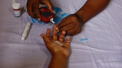 A person receives a free blood sugar test during a diabetes awareness campaign in Dhaka. Reuters