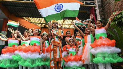 School children carry national flags as they take part in an event on the eve of the India's Independence Day celebrations in Amritsar. AFP
