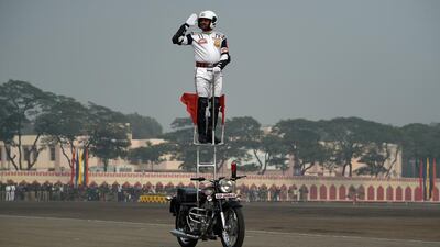 A member of the “Jaan Baaz” team of the Indian Border Security Force demonstrates his motorcycle skills during the BSF Golden Jubilee Day celebration in New Delhi on December 1, 2015. Money Sharma / Agence France-Presse