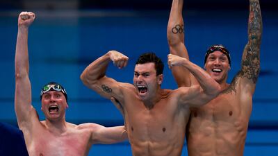 USA's Caeleb Dressel (R), USA's Blake Pieroni (C), and USA's Bowen Becker celebrate winning the Men's 4x100m Freestyle.