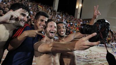 Valencia’s teammates celebrate after winning the UEFA Champions League playoff football match between AS Monaco FC and Valencia CF, at the Louis II Stadium in Monaco. Jean Christophe Magnenet / AFP