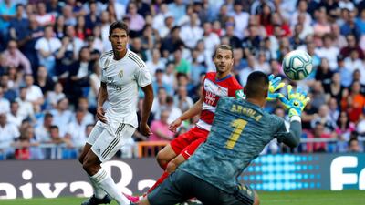 Real Madrid's Raphael Varane sees his shot saved by Granada goalkeeper Alphonse Areola. EPA