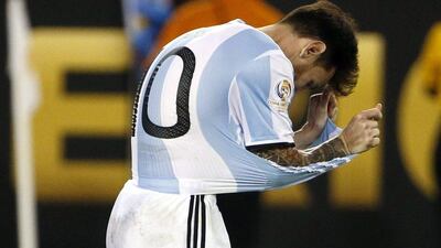 Lionel Messi reacts after missing his penalty shot during the shootout. (EPA/Jason Szenes)