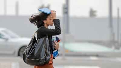 People rush for shelter from the rain at NYU Abu Dhabi. Victor Besa/The National