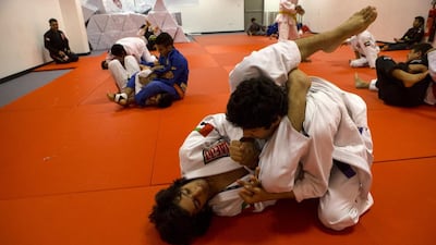 At a young age, Ahmed Al Rejaibi, bottom, knows what he needs to do to become successful in life. Christopher Pike / The National