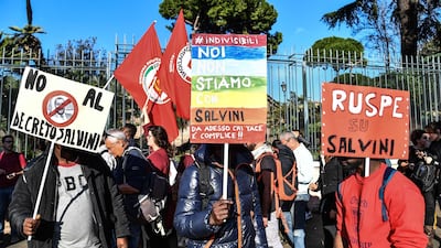 People march during a demonstration against the government's social politics, its recent decree restricting the right to asylum, and against racism in November 2018 in downtown Rome. AFP