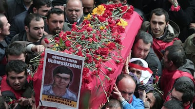 People carry the coffin of Berkin Elvan, a Turkish teenager who was in a coma since being hit on the head by a tear gas canister fired by police during anti-government protests in the summer of 2013, during his funeral in Istanbul on March 12. The placard reads: " Berkin Elvan is immortal!" Emrah Gurel / AP