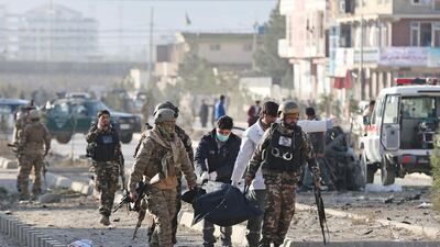 Afghan security forces carry a dead body after a blast in Kabul, Afghanistan. Reuters