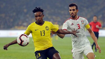 Malaysia's Mohamadou Sumareh, left, olds off Walid Abbas of the UAE. AP