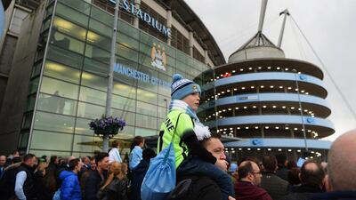 Fans wait for players' arrival prior to a match between Abu Dhabi-owned Manchester City and West Bromwich Albion at the Etihad Stadium in April. Middle East investment has helped to spur City to the top ranks of the English Premier League. Gareth Copley/Getty Images