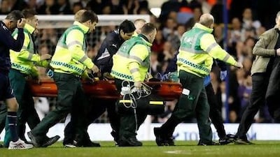 Bolton Wanderers manager Owen Coyle, left, walks alongside the stretcher carrying Fabrice Muamba at White Hart Lane on Saturday.