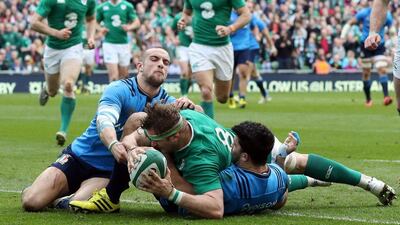 Ireland's number 8 Jamie Heaslip scores their fourth try against Italy on Saturday in a Six Nations victory. Paul Faith / AFP / March 12, 2016