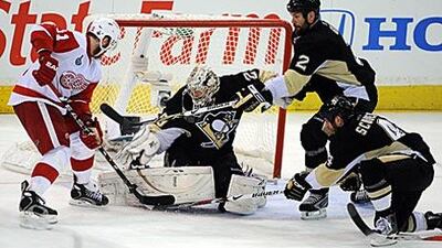 Marian Hossa, left, of the Detroit Red Wings gets denied by the Penguins goaltender Marc-Andre Fleury.