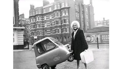 Karen Burch, 20, of Upminster shows how easy it is to park the world's smallest car, the Peel P.50.