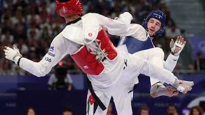 Jordan's Zaid Kareem (red) competes against Britain's Bradly Sinden. AFP
